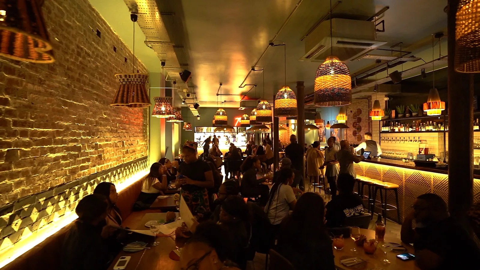 Guests dining together in Monika Restaurant’s warmly lit Deptford dining room