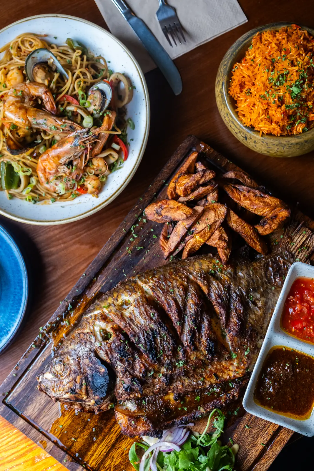 Whole grilled fish, seafood pasta and rice