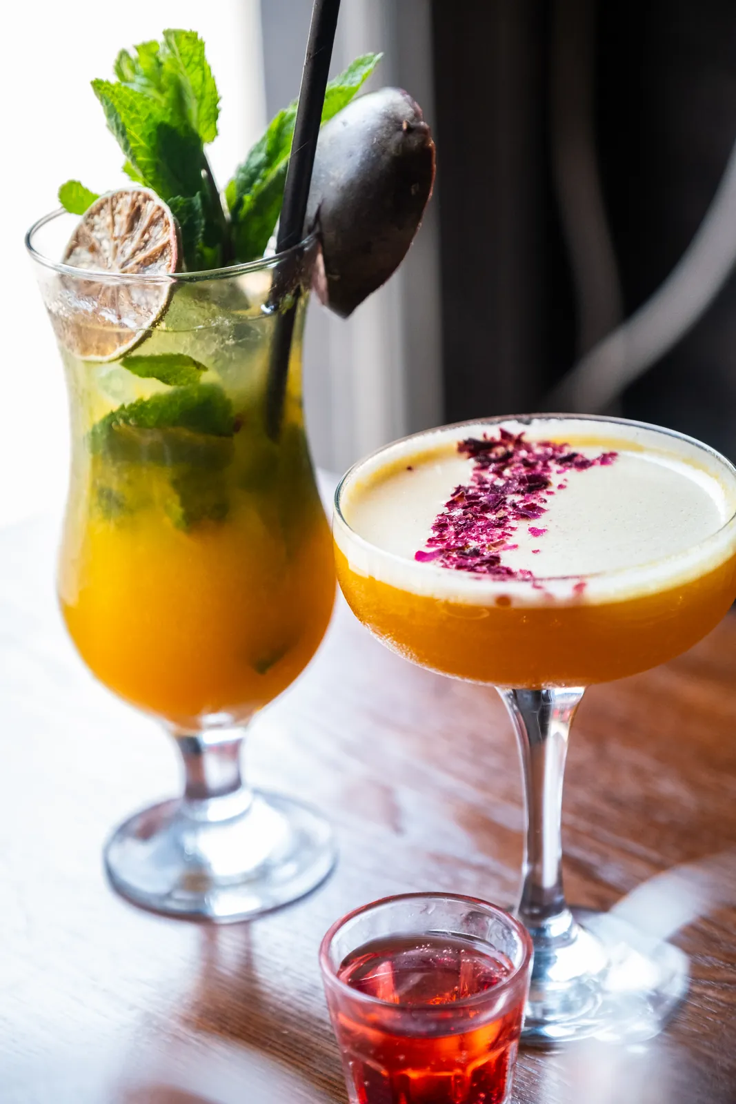 Two freshly prepared cocktails